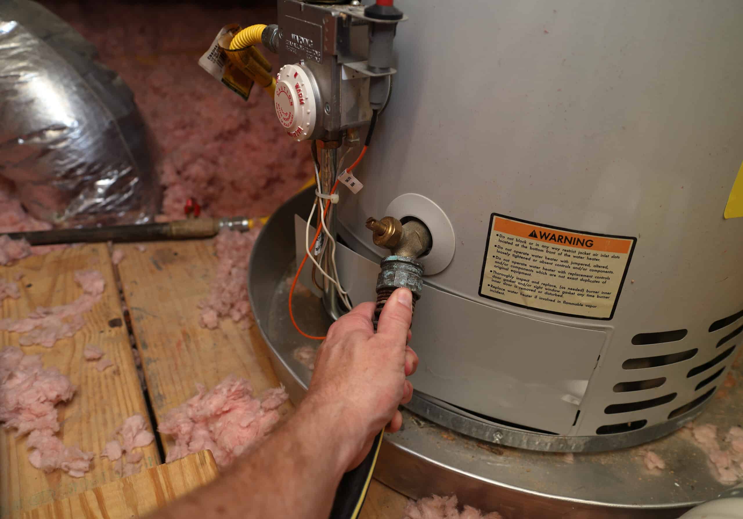 plumber repairing the water heater in a dallas home