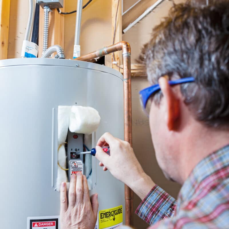 friendly carrollton plumber repairing a home's water heater