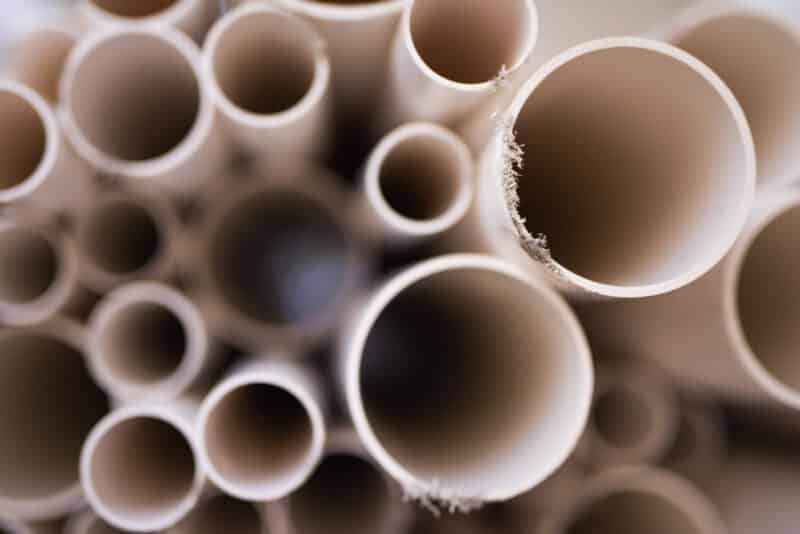 a stack of white pvc pipes inside a warehouse in carrollton texas