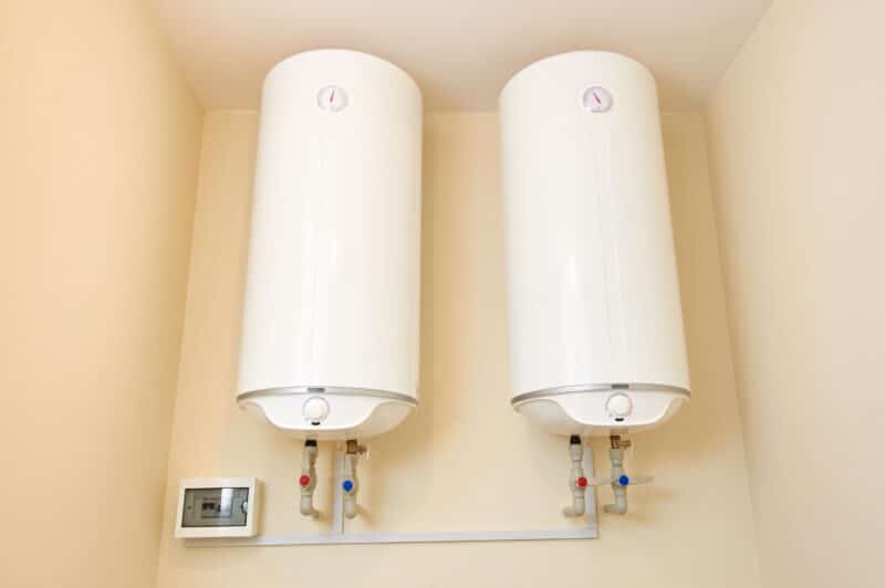 one pair of white tank water heaters installed inside a dallas home