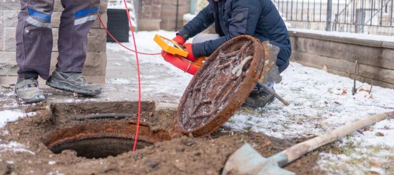 Inspecting sewer with camera equipment outdoors