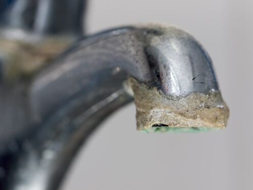limescale hard water buildup on tap